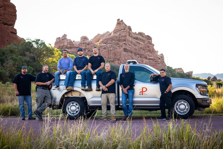 District operators posed by a work truck.